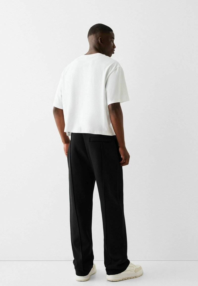 Bershka Bershka WIDE - Tracksuit bottoms - black Online