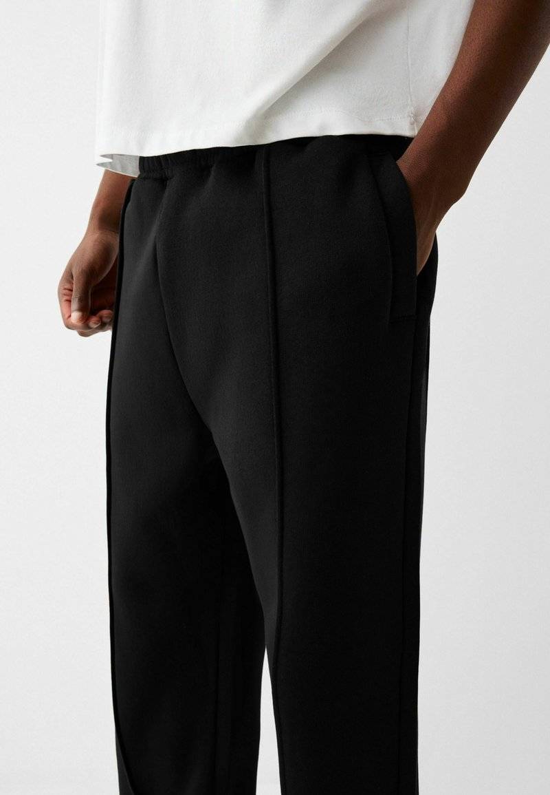 Bershka Bershka WIDE - Tracksuit bottoms - black Online