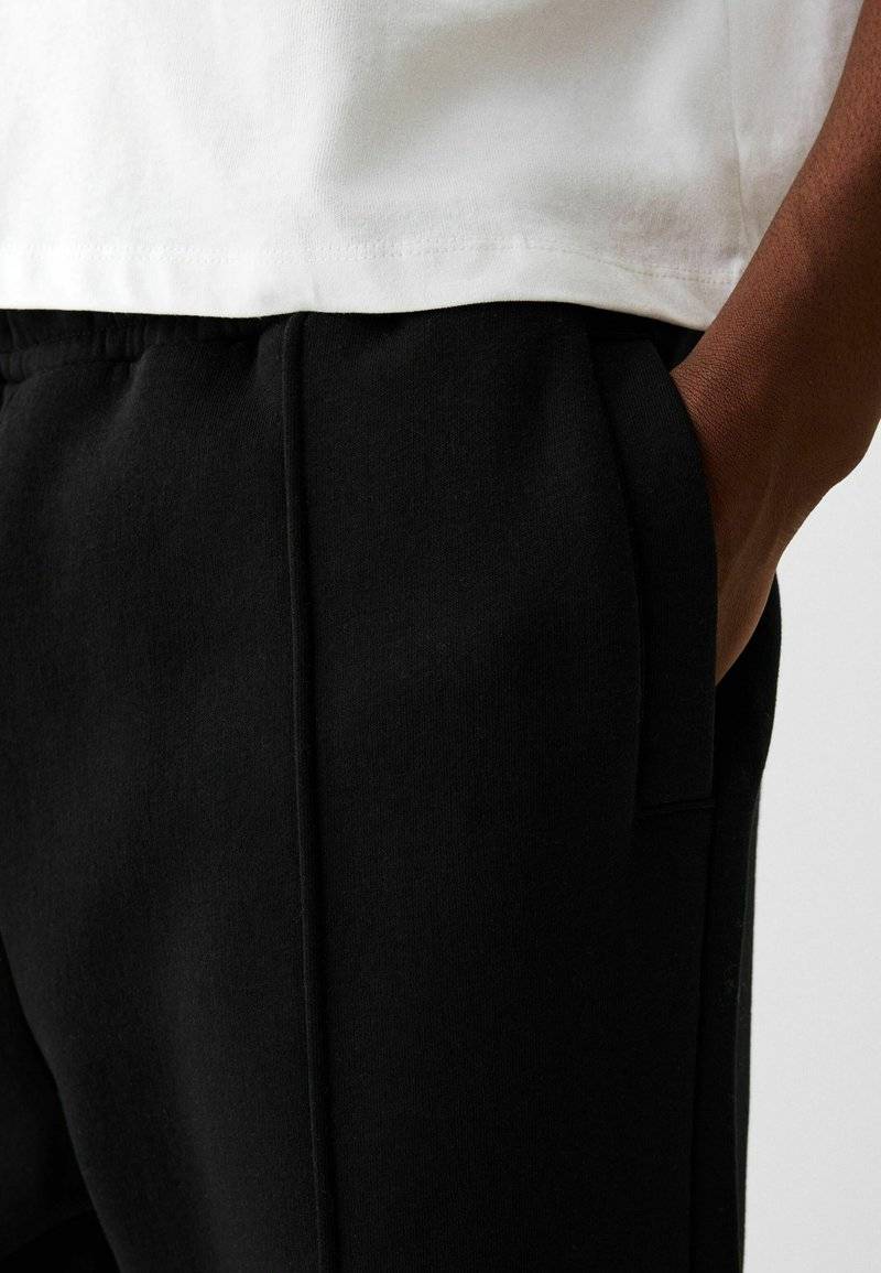 Bershka Bershka WIDE - Tracksuit bottoms - black Online