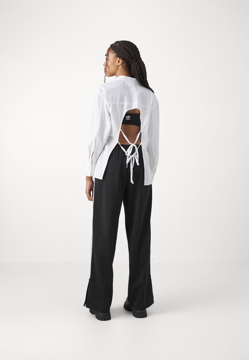 adidas Originals adidas Originals FBIRD LOOSE - Tracksuit bottoms - black Auslauf