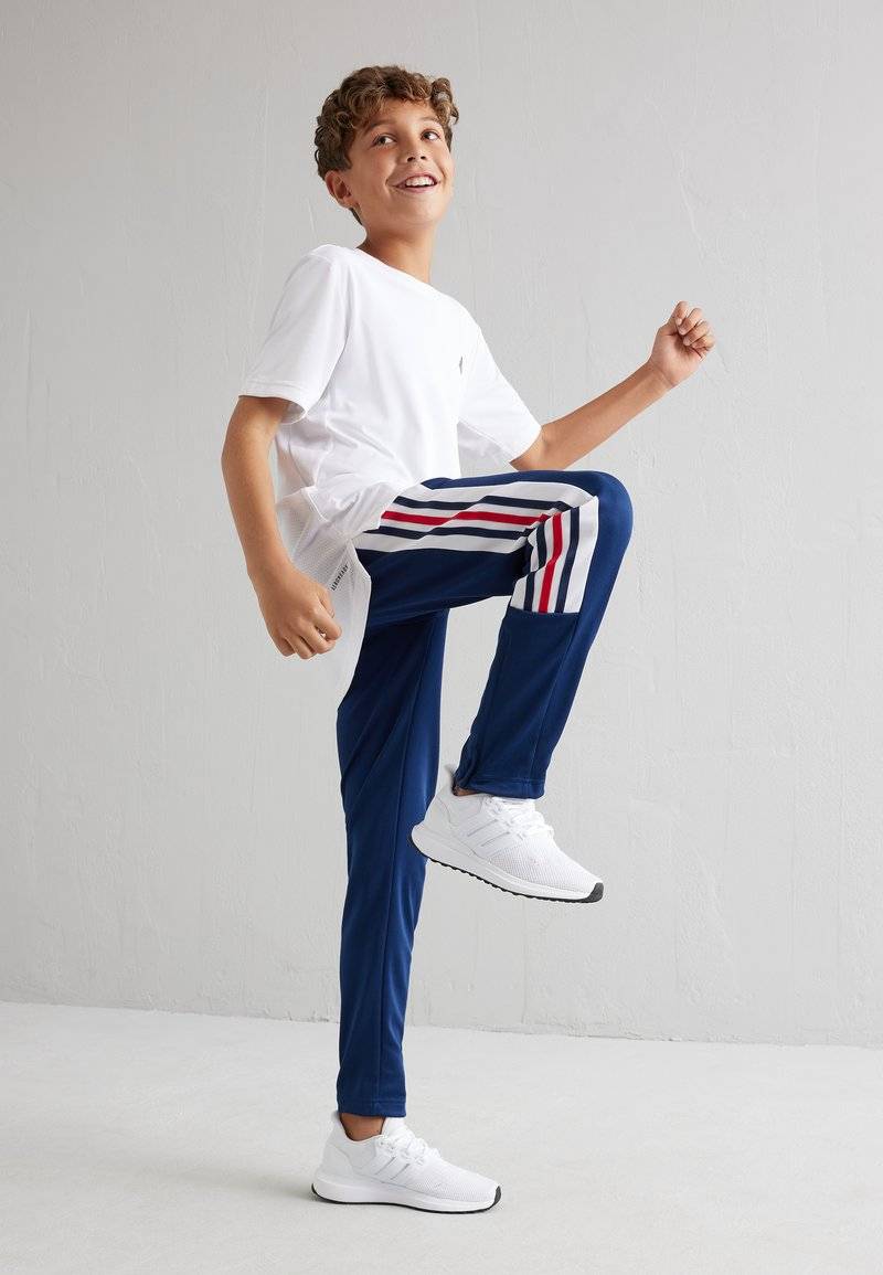 adidas Performance adidas Performance TIRO NATIONS PACK UNISEX - Tracksuit bottoms Nur noch ein Tag übrig