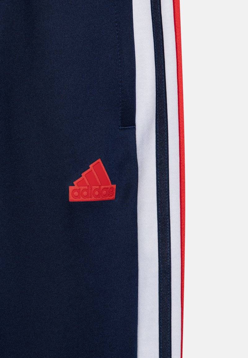 adidas Performance adidas Performance TIRO NATIONS PACK UNISEX - Tracksuit bottoms Nur noch ein Tag übrig