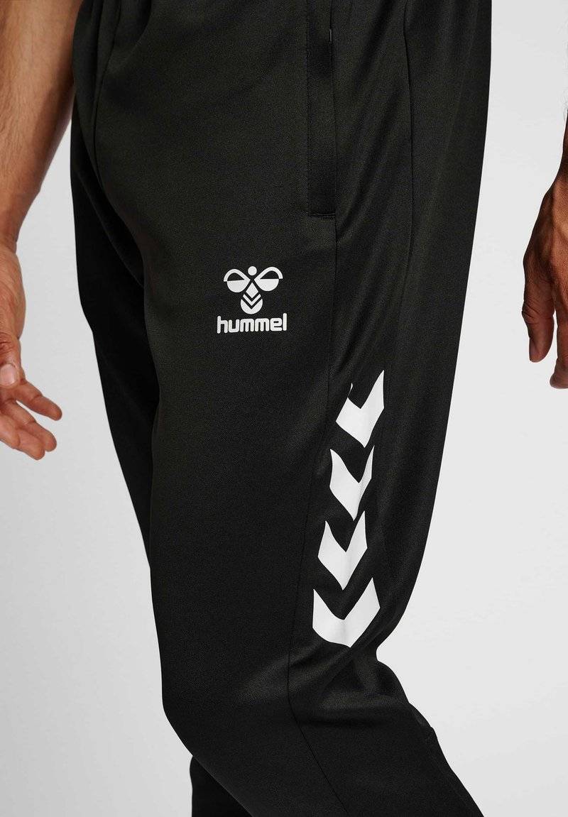 Hummel Hummel CORE XR TRAINING PANTS - Tracksuit bottoms - black Kostenloser Versand international