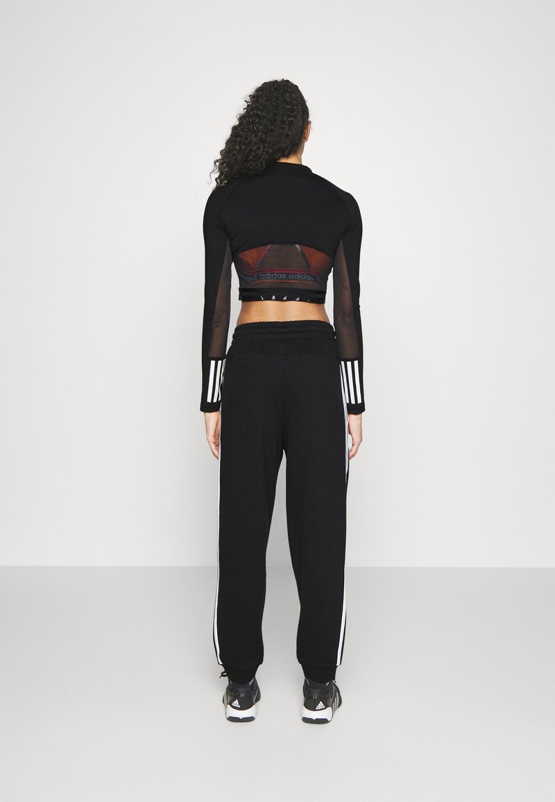 adidas Sportswear adidas Sportswear ESSENTIALS 3-STRIPES LOOSE-FIT - Tracksuit bottoms Auslauf
