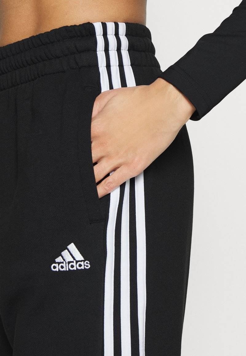 adidas Sportswear adidas Sportswear ESSENTIALS 3-STRIPES LOOSE-FIT - Tracksuit bottoms Auslauf