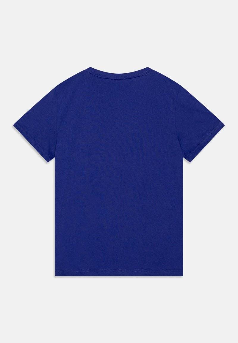 Puma Puma LOGO TEE UNISEX - Print T-shirt - lapis lazuli im Angebot