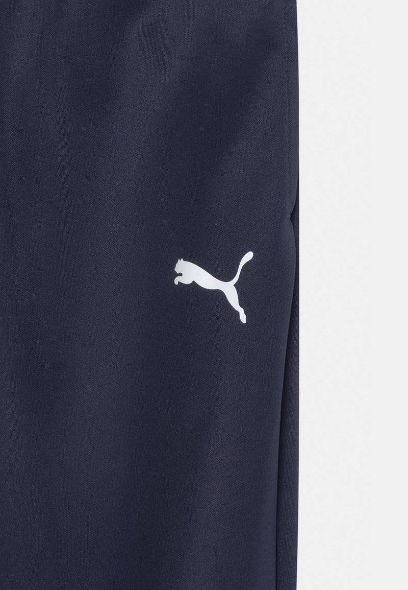 Puma Puma TEAMRISE POLY TRAINING UNISEX - Tracksuit bottoms Bis zu 55% Rabatt