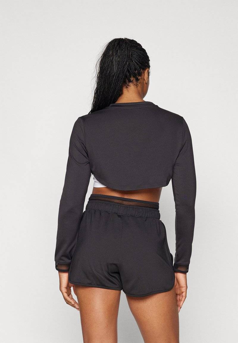 Puma Puma PAMELA REIF CROPPED - Long sleeved top - black Vierteljährliche Förderung