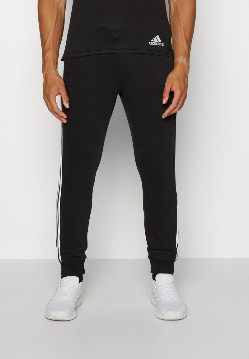 adidas Sportswear adidas Sportswear ESSENTIALS TAPERED CUFF 3 STRIPES PANTS - Tracksuit bottoms - black white Speichern exportieren