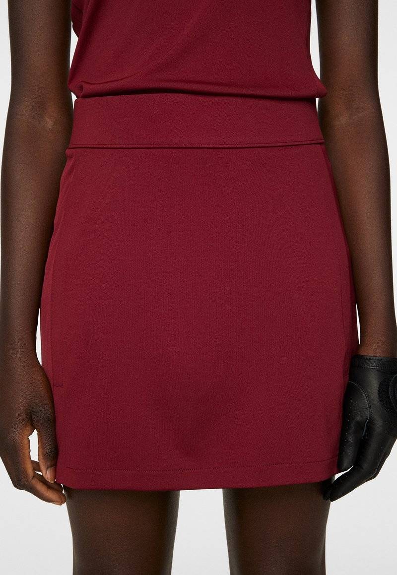 J.LINDEBERG Sports J.LINDEBERG Sports AMELIE MID - Sports skirt - cabernet Limitierter Zeitrabatt